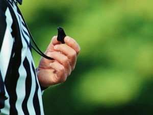 Close-up of Football Referee Holding Whistle
